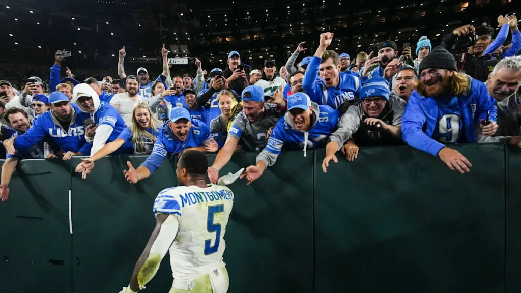 Split shot of the Lambeau crowd amid snowfall and Lions fans cheering.