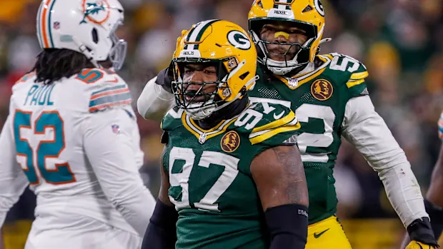 The Cowboys' defensive huddle, focusing on Clark.