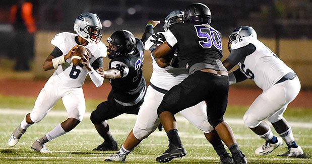 Clark facing a double-team at the line of scrimmage.