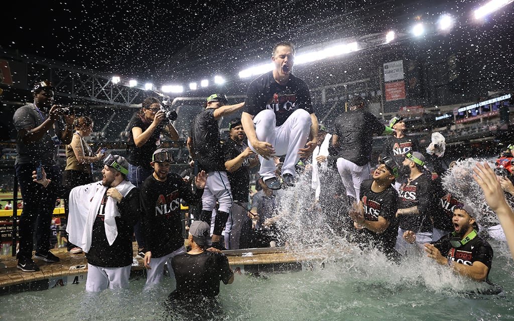 Fans swim in the outfield pool at Chase Field during a Diamondbacks game.