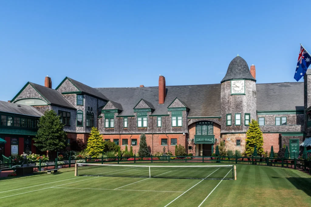 Exterior view of the International Tennis Hall of Fame building with banners of legendary players.