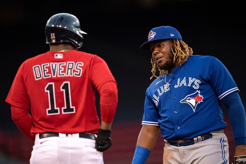 Action Shot Collage – featuring Aaron Judge (Yankees), Rafael Devers (Red Sox), and Vladimir Guerrero Jr. (Blue Jays) with stadium lights behind them and bold text: “Red Sox ⚾ Yankees ⚾ Blue Jays Dominance”
