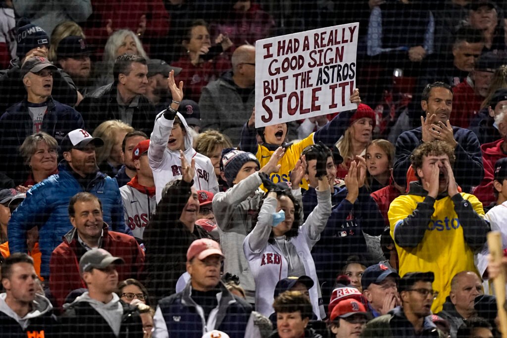 Yankees vs. Red Sox fans at Fenway Park holding rivalry signs