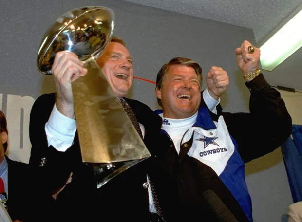 Jerry Jones holding the Lombardi Trophy and players celebrating in the 1990s.