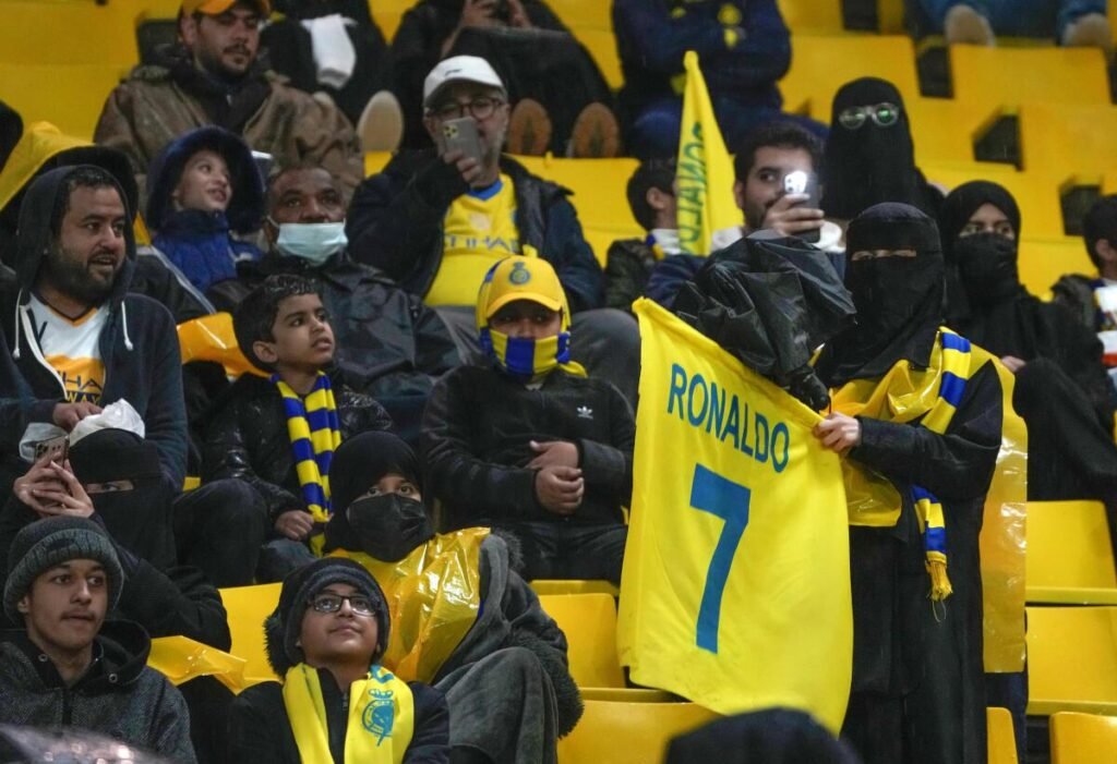 Al-Nassr fans holding Ronaldo banners.