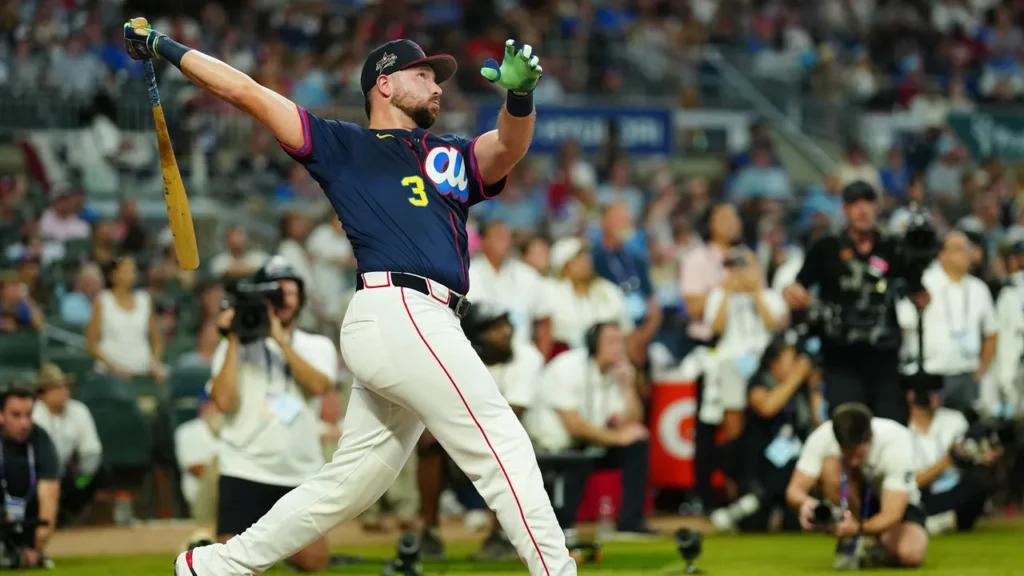 Raleigh admiring his home run as the ball goes into the stands.