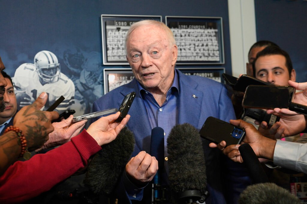 Jerry Jones at a press conference, confidently addressing reporters.