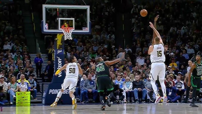 Jokic throwing a pass from behind with defenders around him, Gordon leaping for a dunk.