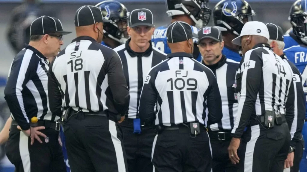 NFL referees leave the field after a heated game.
