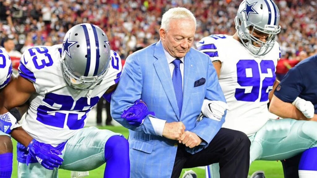 Jerry Jones smiling confidently on the Cowboys' sideline.