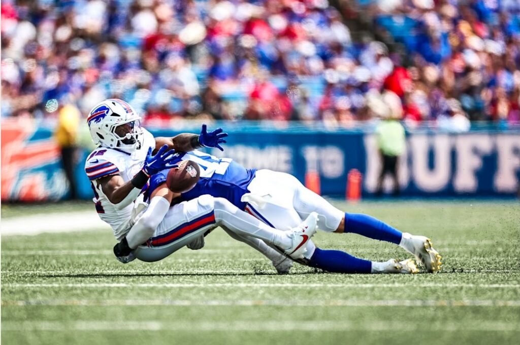 Action-packed split-focus image of Wilson and Dart during a Giants game, showing intensity and anticipation.
