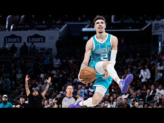 LaMelo is in motion throwing a quick pass, Bridges makes the catch in mid-air.