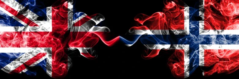  Flags of England and Norway side-by-side on the backdrop of a football pitch.