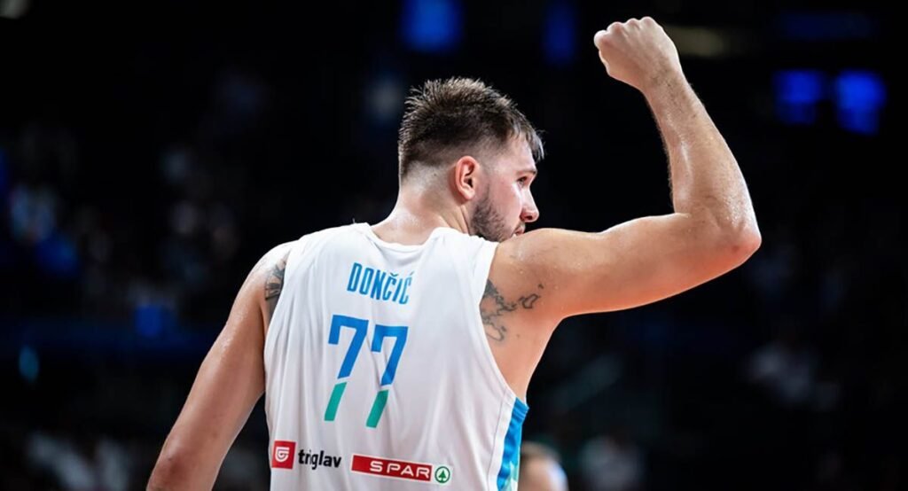 Luka Dončić raises his hand in celebration after Slovenia's win.